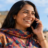A caller in Germany smiling as they talk on the phone